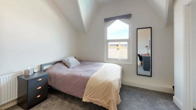 A Cozy Double Bedroom Featuring A Comfortable Bed ...