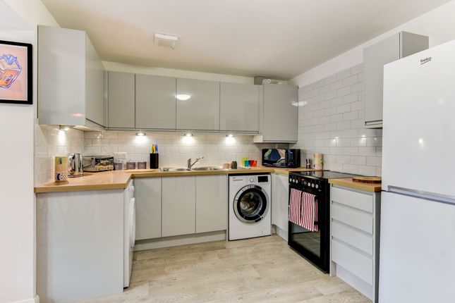 A Modern And Stylish Kitchen Featuring Sleek Cabin...