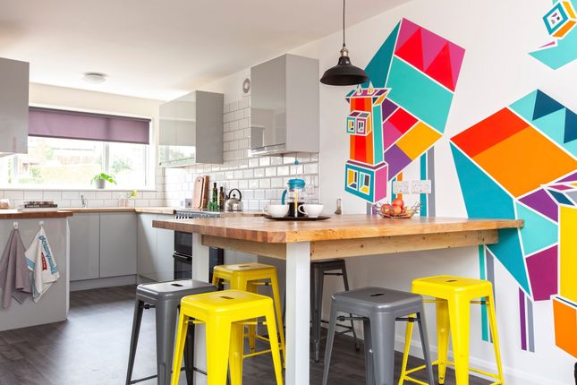A Modern Kitchen Featuring Vibrant Wall Art And A ...