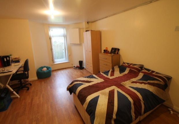 A Cozy Single Bedroom Featuring A Bed With A Union...