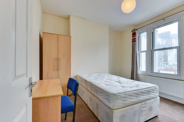 A Bright And Tidy Single Bedroom Featuring A Comfo...