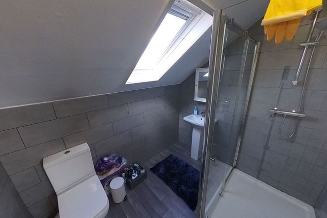 A Clean And Well-Lit Bathroom Featuring A Modern S...