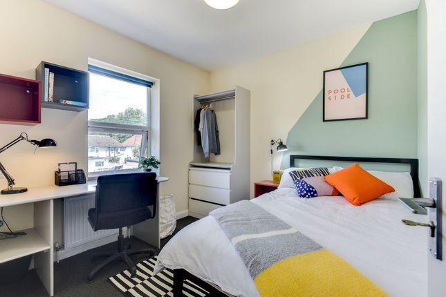 This Cozy Double Bedroom Features A Comfortable Be...