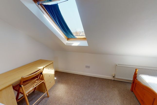 A Cozy Bedroom With A Skylight Providing Natural l...