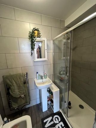 A Clean And Modern Bathroom Featuring A Shower Enc...