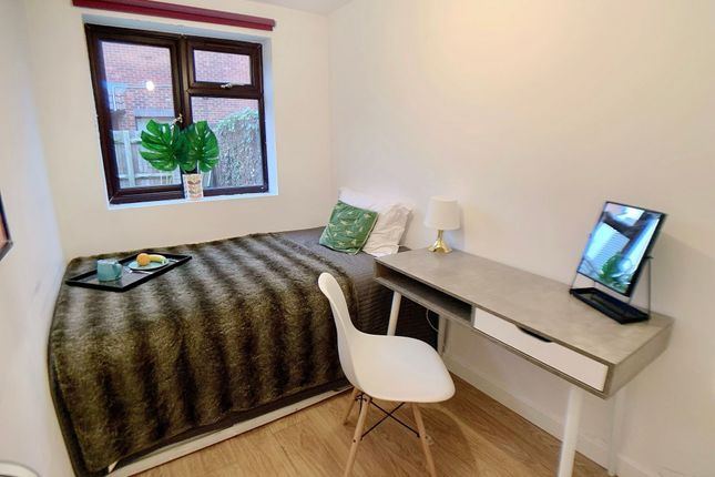 A Cozy Single Bedroom Featuring A Comfortable Bed ...