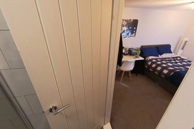 A Cozy Student Bedroom Featuring A Single Bed, A d...