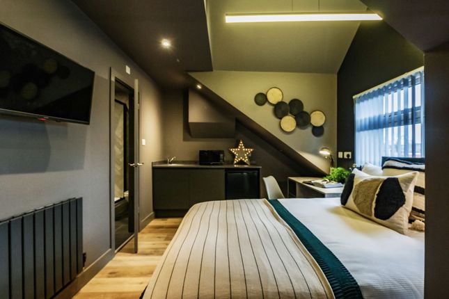 A Spacious And Stylish Master Bedroom Featuring Co...