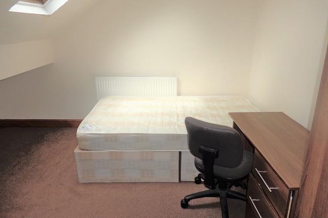 A Bright And Tidy Living Room Featuring Ample Natu...