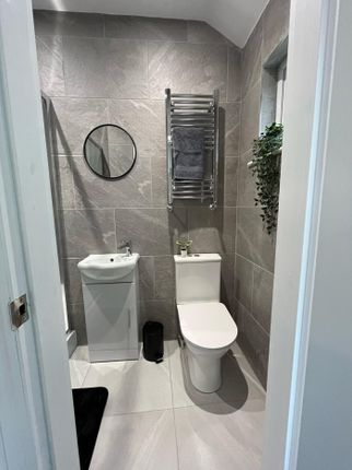 Modern Bathroom Featuring Sleek Tiles, A Stylish R...