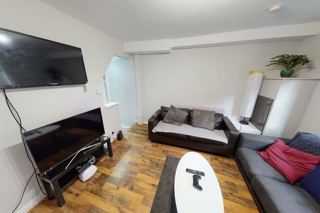 A Spacious And Well-Lit Living Room Featuring A Mo...