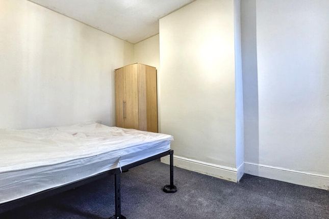 A Neat And Simple Single Bedroom Featuring A Comfo...