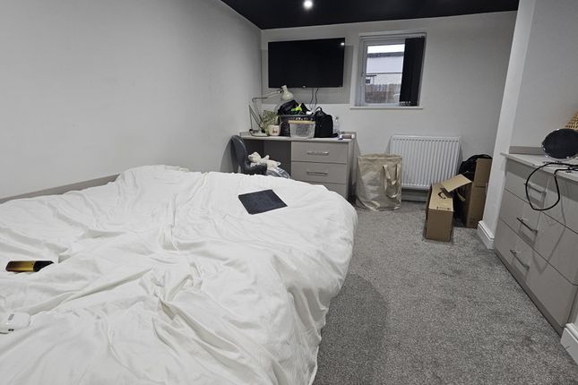 A Well-Maintained Bedroom Featuring A Large Double...