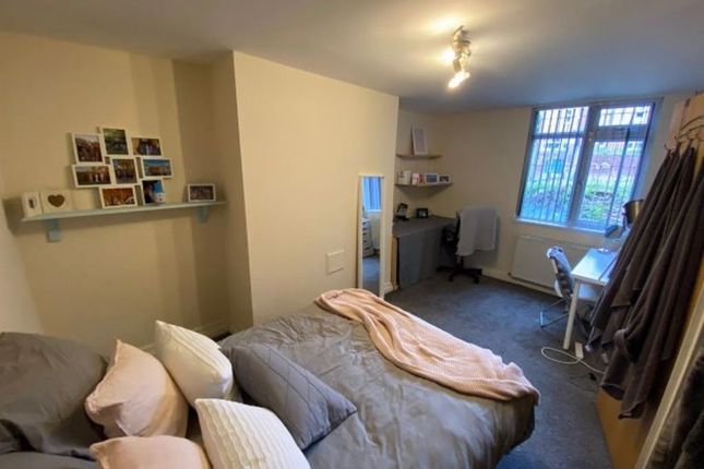 A Cozy Double Bedroom Featuring A Neatly Made Bed ...