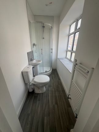 Bright And Tidy Bathroom Featuring A Corner Shower...