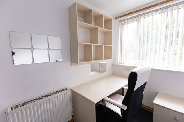 A Bright And Tidy Bedroom Featuring A Clean Desk W...