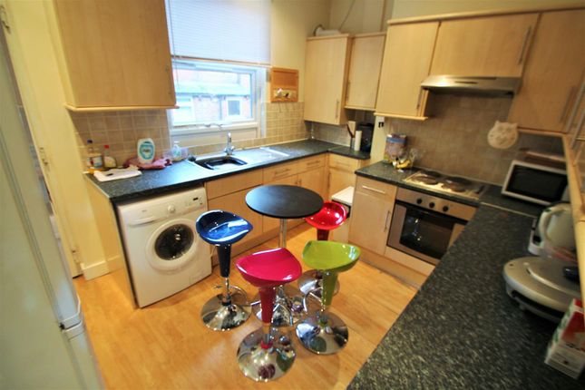 Bright Kitchen With Wooden Cabinetry And Modern Ap...