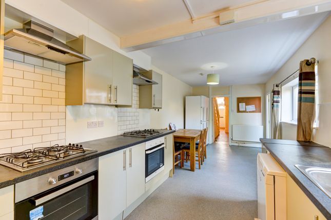 Bright And Modern Kitchen Featuring A Long Counter...