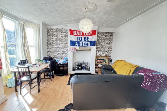 Bright And Stylish Living Room Featuring A Comfort...