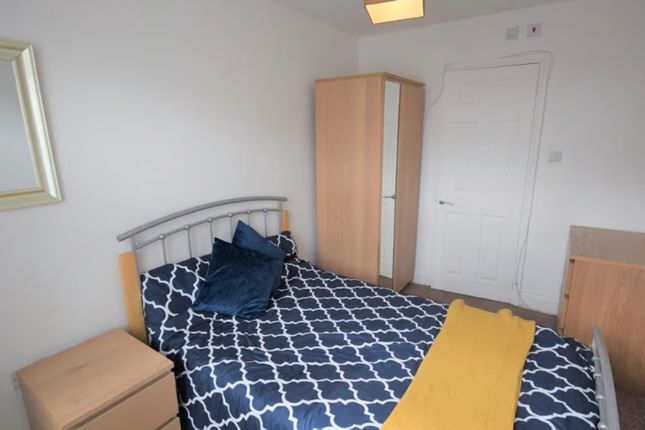 A Cozy Double Bedroom Featuring A Comfortable Bed,...