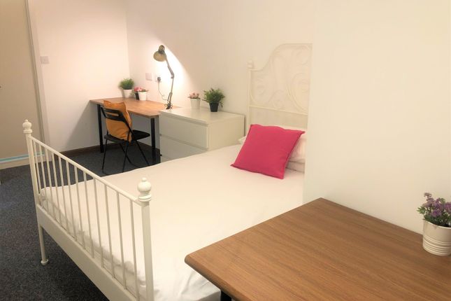 A Bright And Tidy Single Bedroom Featuring A White...