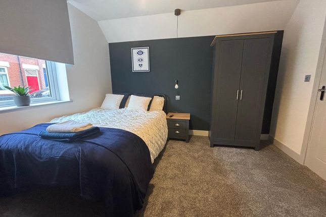 A Cozy Double Bedroom Featuring A Comfortable Bed,...