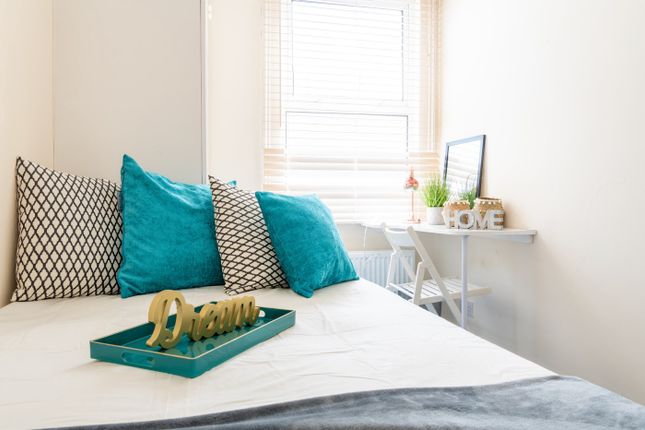 This Cozy Double Bedroom Features Vibrant Teal Cus...