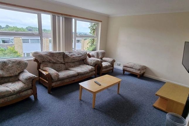A Cozy Living Room Featuring A Set Of Floral Uphol...