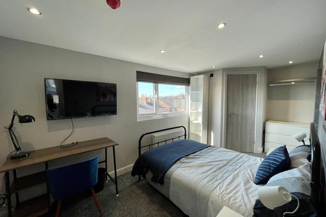 A Stylish Double Bedroom Featuring A Comfortable B...