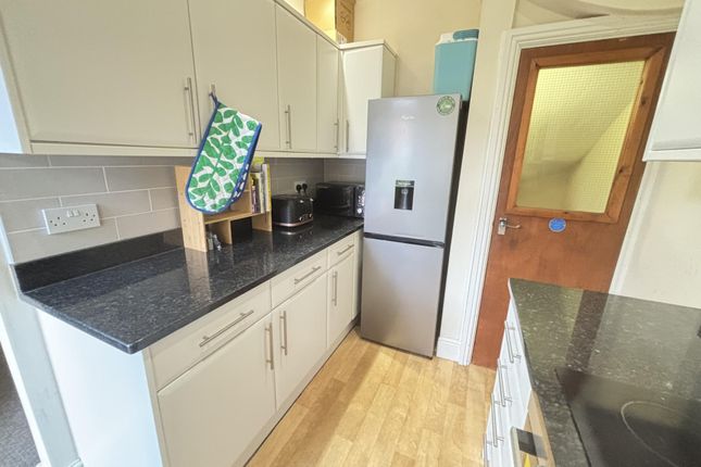 A Bright And Clean Kitchen Area With Modern Cabine...