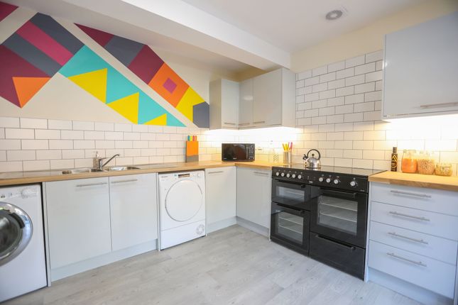 This Vibrant Kitchen Features Modern Appliances An...