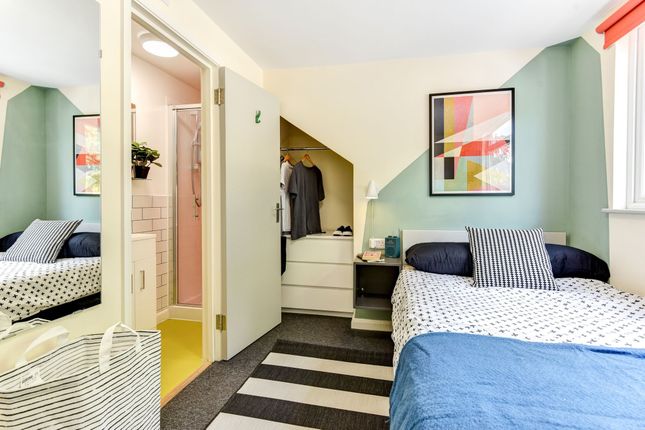 This Inviting Double Bedroom Features A Cozy Layou...
