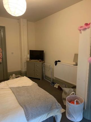 A Cozy Double Bedroom Featuring A Neatly Made Bed ...