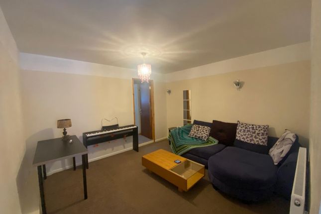 A Cozy Living Room Featuring A Spacious Layout Wit...