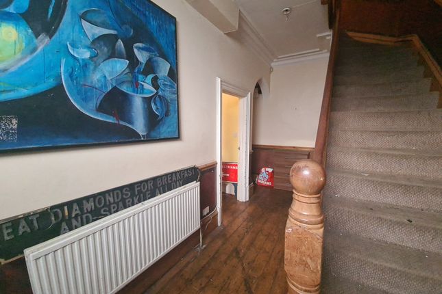 A Welcoming Hallway Featuring Warm Wooden Flooring...