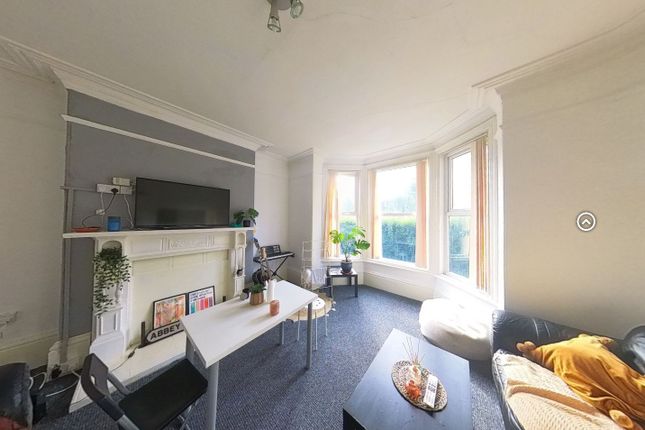 A Bright And Inviting Living Room Featuring A Larg...