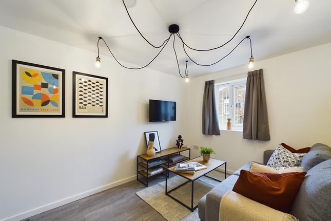 A Bright And Inviting Living Room Featuring Contem...