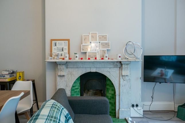 Modern Living Room Featuring A Fireplace With Deco...
