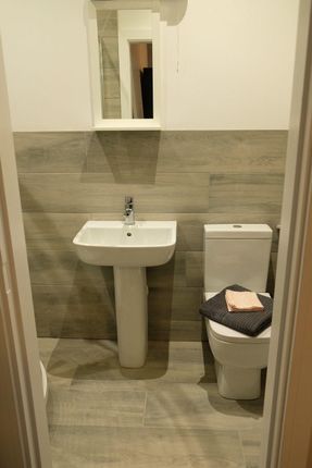 A Modern And Clean Bathroom Featuring A Pedestal S...