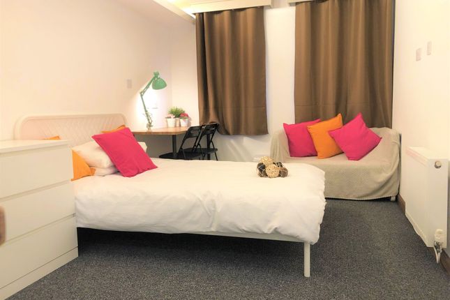 A Cozy Single Bedroom Featuring A Neatly Made Bed ...