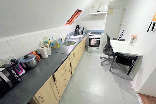 A Neat And Functional Kitchen Featuring A Long Cou...