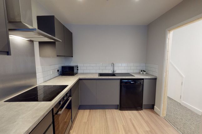 A Modern And Tidy Kitchenette Featuring Sleek Cabi...