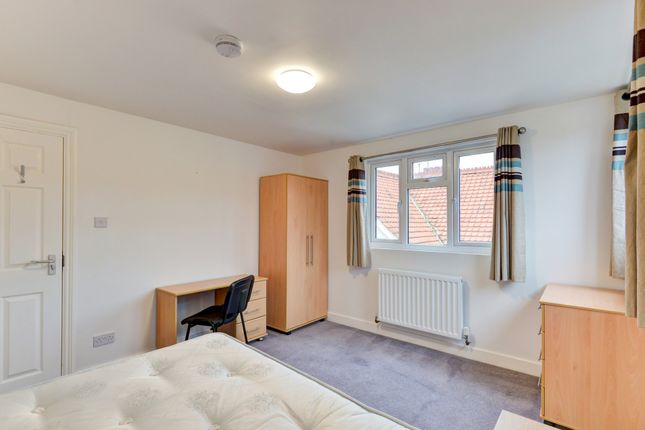 A Bright, Well-Maintained Bedroom Featuring Two La...