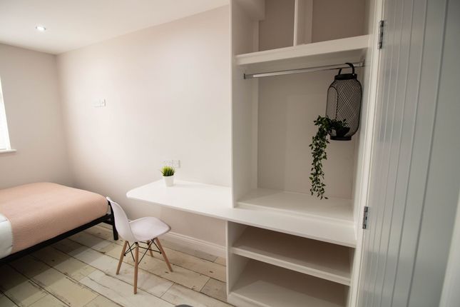 A Bright, Modern Bedroom Featuring A Cozy Bed With...