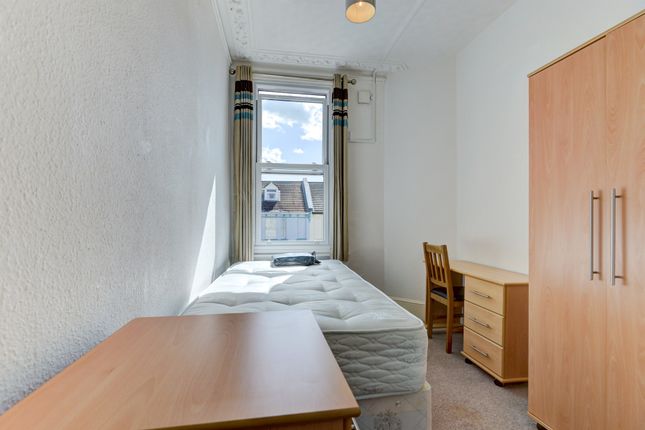 A Bright And Tidy Single Bedroom Featuring A Large...