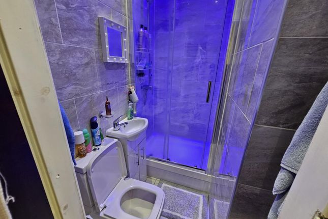 A Clean And Modern Bathroom Featuring A Shower Enc...