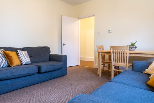A Bright And Inviting Living Room Featuring Comfor...