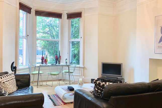 A Bright And Welcoming Living Room Featuring Large...