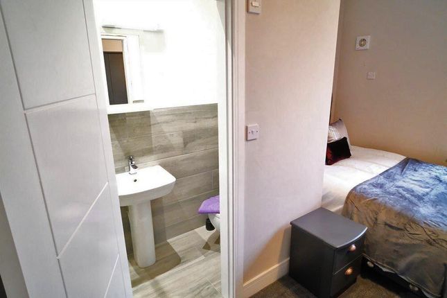 Compact And Clean Single Toilet Adjacent To A Cozy...