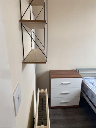 A Cozy Bedroom Featuring A Neatly Made Bed And A m...